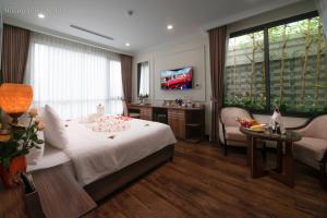 Voodi või voodid majutusasutuse Hillary Hanoi Hotel toas