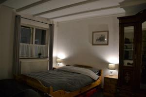 het Bakhuis في Hoensbroek: غرفة نوم بسرير ونافذة ومصباحين