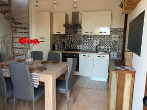 a kitchen with a wooden table and blue chairs at Villa Mimma in Taormina