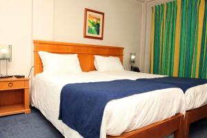 Posteľ alebo postele v izbe v ubytovaní Hotel Paraiso
