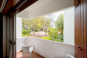 a view from the balcony of a house with a large window at AL - Apartamento Impervila in Vilamoura