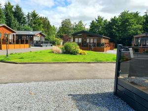 a group of houses in a park with a building at Grand Eagles Luxury Lodge, Auchterarder in Perth