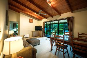 a living room with a couch and a table at Bundara - Idyllic Getaway in the Mountains in Mount Tamborine