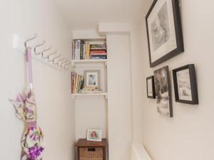 a hallway with bookshelves and pictures on the wall at The Art Studio in Bath