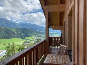 a balcony with a bench and a view of a valley at LA MONTANA - Ski & Hiking LODGE in Schladming