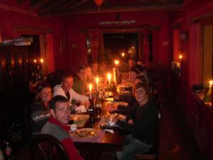 a large group of people sitting at a dinner table at The Secret Garden Cotopaxi in Hacienda Porvenir