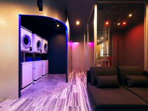 a living room with a couch and two microwaves at Hotel Pivot Shin-Imamiya Ekimae in Osaka