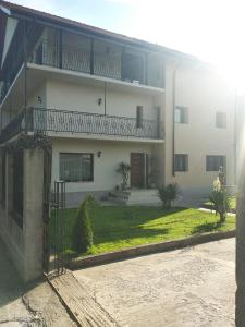 a white building with a balcony on the side of it at Casa Simone in Costinesti