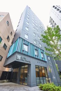 a building with a sign on the side of it at ICI HOTEL Tokyo Hatchobori in Tokyo