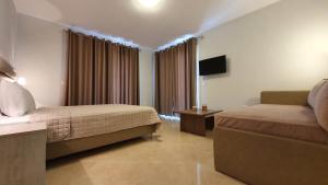a hotel room with a bed and a couch at Vasiliki House in Sarti