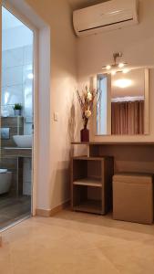 a bathroom with a sink and a mirror at Vasiliki House in Sarti