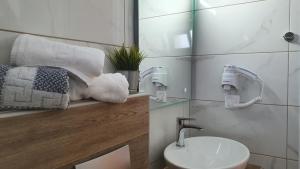 a bathroom with a sink and a toilet and towels at Vasiliki House in Sarti