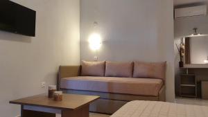 a living room with a couch and a table at Vasiliki House in Sarti