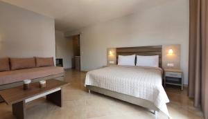 a hotel room with a bed and a couch at Vasiliki House in Sarti