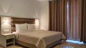 a hotel room with a bed and a window at Vasiliki House in Sarti