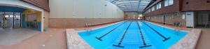 a large swimming pool in a large building at Wollongong Surf Leisure Resort in Wollongong