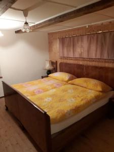 a bedroom with a large bed with a wooden frame at Tepilanti in Cerentino