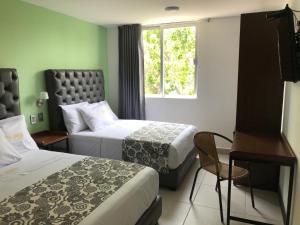 Krevet ili kreveti u jedinici u objektu Hotel Jar8 Acuario enfrente al Acuario de Veracruz