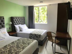 Postel nebo postele na pokoji v ubytování Hotel Jar8 Acuario enfrente al Acuario de Veracruz