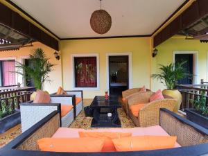 
a living room filled with furniture and a balcony at Villa Indochine D'angkor in Siem Reap
