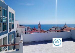 a view of the ocean from a balcony of a building at Vila Algarvia Boutique & Suites in Albufeira