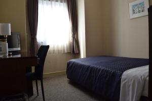 Postel nebo postele na pokoji v ubytování Asakusa Central Hotel