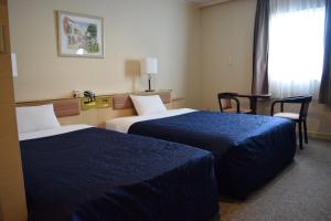 Postel nebo postele na pokoji v ubytování Asakusa Central Hotel