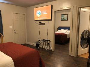a room with a bed and a television in it at Angeles Motel in Port Angeles