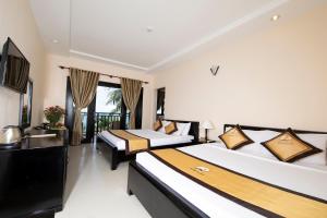 a bedroom with two beds and a balcony at Hon Rom Central Beach Resort in Mui Ne