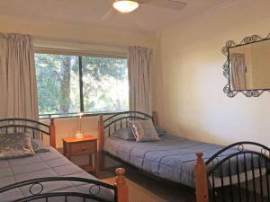 a bedroom with two beds and a window at The Poplars, 15,36 Magnus Street - Unit in a great complex with a pool and close to town in Nelson Bay