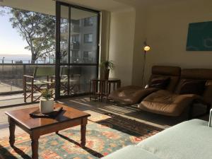a living room with a couch and a table at The Poplars, 15,36 Magnus Street - Unit in a great complex with a pool and close to town in Nelson Bay