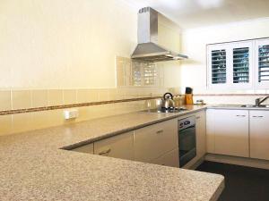 a large kitchen with a sink and a stove at The Poplars, 15,36 Magnus Street - Unit in a great complex with a pool and close to town in Nelson Bay