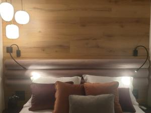 a headboard with two lights above a bed with pillows at EcoStay-Serenity,business class apartment by the sea in Alimos Kalamaki# in Athens