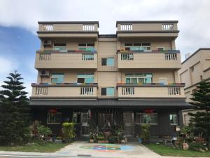 a tall building with balconies on top of it at Dai B&B in Jincheng