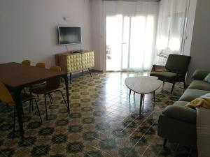 ein Wohnzimmer mit einem Tisch und einem Sofa in der Unterkunft A3A Marina View in Torredembarra
