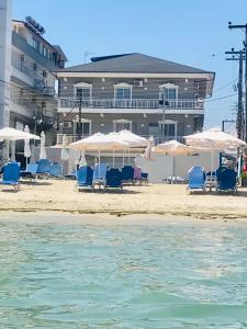 a group of chairs and umbrellas on a beach at Nisel Seaside in Paralia Katerinis