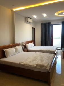 Postel nebo postele na pokoji v ubytování Kim Ngoc Khanh Hotel