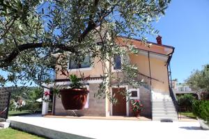 a house with a potted tree in front of it at Residence Villa Fiore Portorož in Portorož