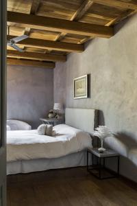 a bedroom with a large white bed and a table at Residenza Farnese in Farnese