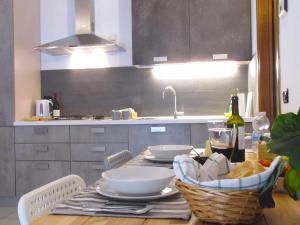 a kitchen with a table with plates and bowls on it at Vicenza City Apartments 1 in Vicenza