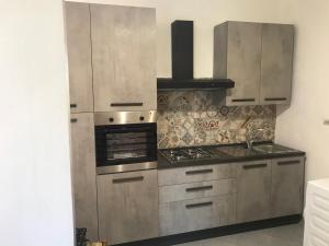 a kitchen with stainless steel cabinets and a stove at Terrazza sul mare - Villa Tota - in Ardore Marina