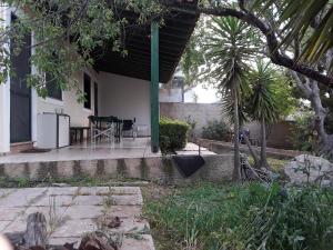 a house with a patio with a table and a refrigerator at Calm Point Home 2 in Volissos