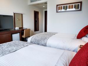 Postel nebo postele na pokoji v ubytování HOTEL MYSTAYS Maihama