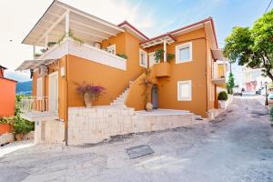 a house with orange paint on it at ASTRA in Parga