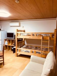 a room with a bunk bed with a couch at Ichijyo IVY 5 persons room in Kyoto