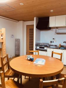 a kitchen with a wooden table with chairs and a dining room at Ichijyo IVY 5 persons room in Kyoto