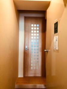 a wooden door in a hallway with a sign on it at Ichijyo IVY 5 persons room in Kyoto