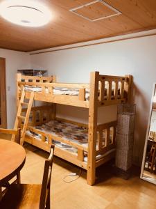 a wooden bunk bed in a room with a table at Ichijyo IVY 5 persons room in Kyoto