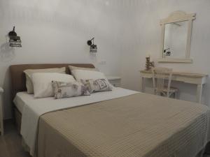 a bedroom with a bed with a table and a mirror at SgS Luxury Apartments in Xylokastro