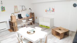 a living room with a table and chairs and a desk at Big Appartment near trade fair! in Cologne